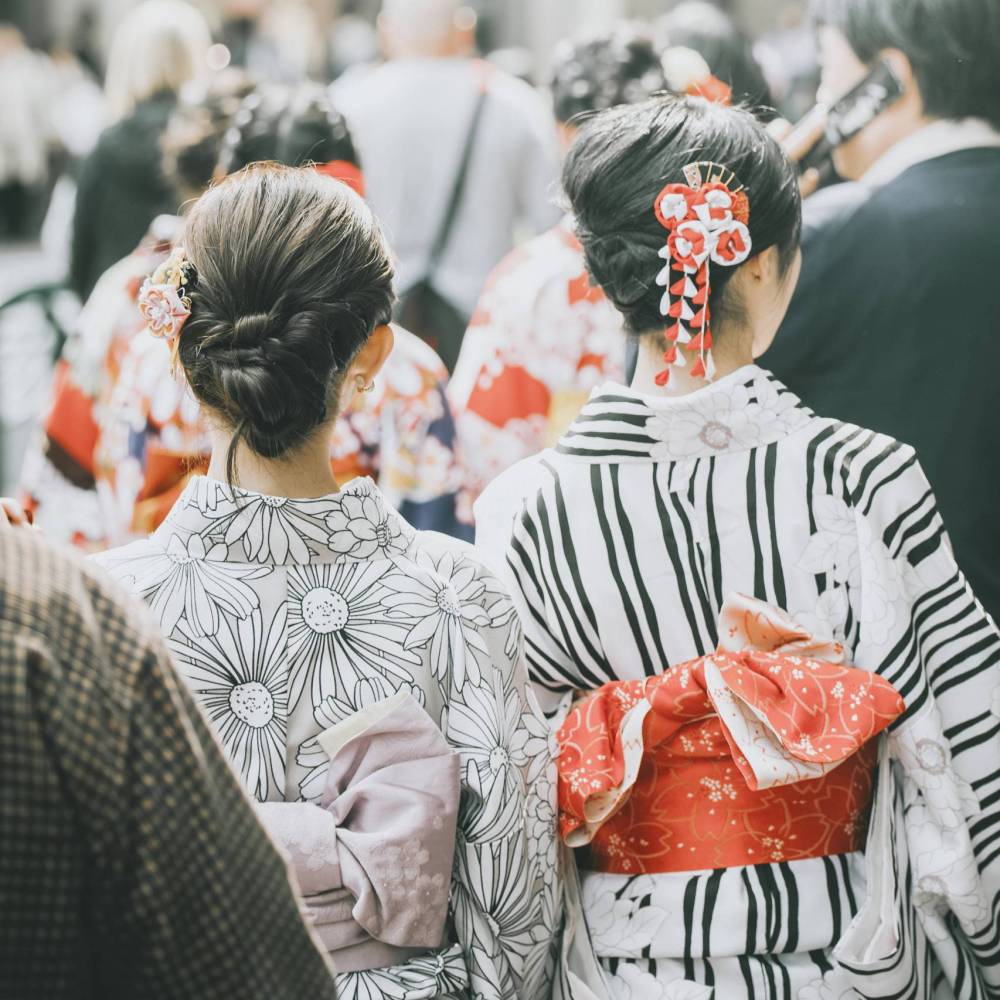 Rear view of Japanese women in yukata among the crowd